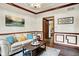 Bright living room features beautiful crown molding, hardwood floors, and a comfortable sofa at 5377 Crooked Stick Ct, Greenwood, IN 46142