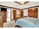 Bright and airy bedroom with neutral walls, wood trim, a tray ceiling, and double closet doors at 5377 Crooked Stick Ct, Greenwood, IN 46142