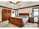 Bright and airy main bedroom featuring wood trim, a tray ceiling, and double closet doors at 5377 Crooked Stick Ct, Greenwood, IN 46142