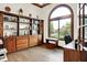 Bright office space with built-in shelves, drawers, a bench, and a large window with a backyard view at 5377 Crooked Stick Ct, Greenwood, IN 46142