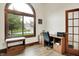 Cozy office space with a large window, wood-look floors, a desk area, and a cat tree at 5377 Crooked Stick Ct, Greenwood, IN 46142