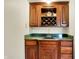 Stylish wet bar with wooden cabinetry, a sink, and built-in wine storage for entertaining at 5377 Crooked Stick Ct, Greenwood, IN 46142