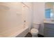 Clean bathroom with a shower-tub combo, toilet, vanity, and light gray cabinets at 5540 Tart Blvd, Indianapolis, IN 46239