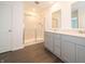Modern bathroom with a double vanity, tiled walk-in shower, and gray cabinets at 5540 Tart Blvd, Indianapolis, IN 46239