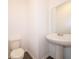 Neutral half-bath features a pedestal sink, wood-look vinyl flooring and a comfort height toilet at 5540 Tart Blvd, Indianapolis, IN 46239