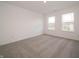 Bright bedroom with neutral carpeting and a view of the neighborhood at 5540 Tart Blvd, Indianapolis, IN 46239