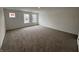 Large, carpeted bedroom with abundant natural light from three windows, creating a spacious and inviting atmosphere at 5540 Tart Blvd, Indianapolis, IN 46239