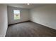 Carpeted bedroom with natural light from a single window, offering a cozy atmosphere and blank canvas at 5540 Tart Blvd, Indianapolis, IN 46239