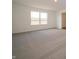 Bright bedroom with neutral carpeting, a large window, and a doorway at 5540 Tart Blvd, Indianapolis, IN 46239
