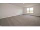 Spacious bedroom with plush carpeting, a large window, and a view of the outdoors at 5540 Tart Blvd, Indianapolis, IN 46239