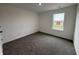 An empty bedroom with carpet flooring and a window allowing natural light at 5540 Tart Blvd, Indianapolis, IN 46239