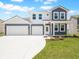 Charming two-story home with a two-car garage, well-manicured lawn, and welcoming front porch at 5540 Tart Blvd, Indianapolis, IN 46239