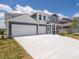 Beautiful exterior featuring a large driveway and gray siding, complemented by well-maintained landscaping at 5540 Tart Blvd, Indianapolis, IN 46239