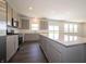 Open kitchen featuring a large island, stainless steel appliances, stone countertops, and ample cabinet space at 5540 Tart Blvd, Indianapolis, IN 46239