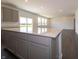 Open concept kitchen with gray cabinets, a large island, stone countertops, and stainless steel appliances at 5540 Tart Blvd, Indianapolis, IN 46239
