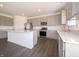 Modern kitchen with stainless steel appliances, gray cabinets with stone countertops, and a large center island at 5540 Tart Blvd, Indianapolis, IN 46239