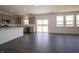 Open-concept kitchen with gray cabinets, stainless steel appliances, island, and sliding glass doors to the backyard at 5540 Tart Blvd, Indianapolis, IN 46239