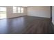 Spacious living room with dark hardwood floors, and large windows allowing for plenty of natural light at 5540 Tart Blvd, Indianapolis, IN 46239