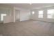Bright living room featuring neutral carpeting and multiple windows for natural light at 5540 Tart Blvd, Indianapolis, IN 46239