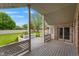 Inviting outdoor space with a covered porch and deck, featuring a lovely view of the well-maintained backyard at 5601 W Sun Point Dr, Muncie, IN 47304