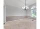 Spacious dining room features a decorative chandelier and natural light from the large arched window at 5601 W Sun Point Dr, Muncie, IN 47304