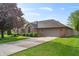 Lovely single-story brick home with an attached two-car garage, showcasing a well-maintained lawn and driveway at 5601 W Sun Point Dr, Muncie, IN 47304