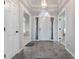 Inviting foyer with tiled flooring, arched doorway, and ample natural light streaming through the front door at 5601 W Sun Point Dr, Muncie, IN 47304