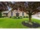 Charming brick home featuring a well-manicured lawn and mature trees in a desirable neighborhood at 5601 W Sun Point Dr, Muncie, IN 47304