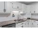 Bright kitchen featuring white cabinets, granite countertops, stainless steel appliances, and ample workspace at 5601 W Sun Point Dr, Muncie, IN 47304