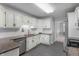 Well-maintained kitchen featuring white cabinetry, granite countertops, and stainless steel appliances at 5601 W Sun Point Dr, Muncie, IN 47304