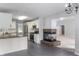 Spacious kitchen with granite countertops, white cabinets, tile flooring, and seamless flow into the living area at 5601 W Sun Point Dr, Muncie, IN 47304