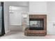 Inviting living room featuring a brick fireplace, mantle, and seamless flow to the dining and kitchen areas at 5601 W Sun Point Dr, Muncie, IN 47304