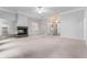 Open living room features a brick fireplace, neutral walls, and a ceiling fan for a comfortable, inviting space at 5601 W Sun Point Dr, Muncie, IN 47304