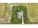 An aerial view of the property featuring a spacious lawn, mature trees, and a charming home at 5855 S 25 W, Lebanon, IN 46052