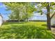 Expansive backyard with lush lawn, mature trees, and privacy fence, perfect for outdoor activities at 5855 S 25 W, Lebanon, IN 46052