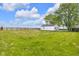 Spacious backyard with green grass and shed, offering ample space for outdoor enjoyment and storage at 5855 S 25 W, Lebanon, IN 46052