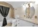 Well-lit bathroom features a tub with shower, stylish fixtures, and decorative wall lighting at 5855 S 25 W, Lebanon, IN 46052