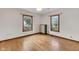 Bright bedroom featuring hardwood floors, white walls, and natural lighting from two windows at 5855 S 25 W, Lebanon, IN 46052