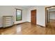Simple bedroom showcasing hardwood floors, natural light, and a vintage dresser at 5855 S 25 W, Lebanon, IN 46052