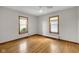 Bedroom features hardwood floors, neutral walls, and natural lighting from two windows at 5855 S 25 W, Lebanon, IN 46052
