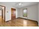 Spacious bedroom featuring hardwood floors, natural light, and a classic wooden door at 5855 S 25 W, Lebanon, IN 46052