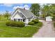 Exterior of the home featuring manicured shrubs and a detached garage on a lush lot at 5855 S 25 W, Lebanon, IN 46052