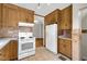 Bright kitchen features white appliances and cabinets with direct access to hardwood floors at 5855 S 25 W, Lebanon, IN 46052