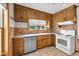 Traditional kitchen features wood cabinets, stainless dishwasher, and white appliances at 5855 S 25 W, Lebanon, IN 46052