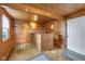 Cozy living space featuring wood walls, ceiling, bar area, and a window for natural light at 5855 S 25 W, Lebanon, IN 46052