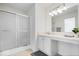 Well-lit bathroom with a sliding glass door shower, vanity, sink, and vanity mirror at 5893 Crosscut Ln, Noblesville, IN 46062