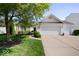 Charming single-Gathering home featuring an attached two-car garage, well-maintained lawn, and mature trees at 5893 Crosscut Ln, Noblesville, IN 46062