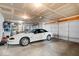 Spacious garage featuring overhead lighting, storage shelving, and an automatic garage door at 5893 Crosscut Ln, Noblesville, IN 46062
