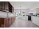 Open kitchen/dining area with wood cabinets and lots of natural light at 5893 Crosscut Ln, Noblesville, IN 46062