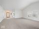 Bright and spacious living room featuring neutral carpeting, high ceilings, and ample natural light at 5893 Crosscut Ln, Noblesville, IN 46062
